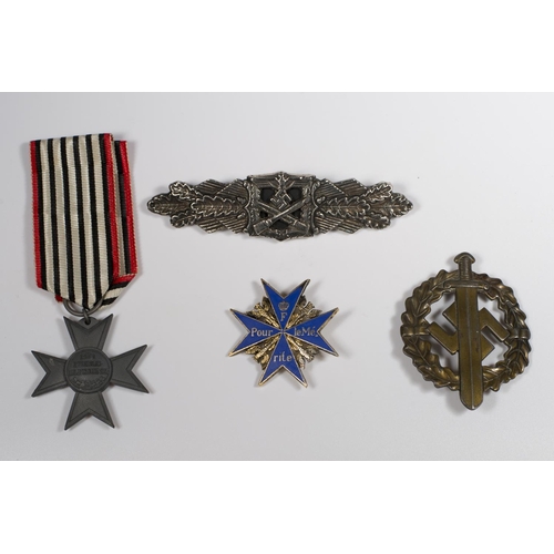 337 - Four replica German Second World War medals and badges