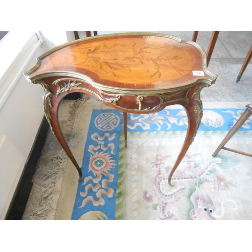 56 - A French table with leaf shaped hinged top, marquetry inlaid to coral and shell, brass bound, on sle... 