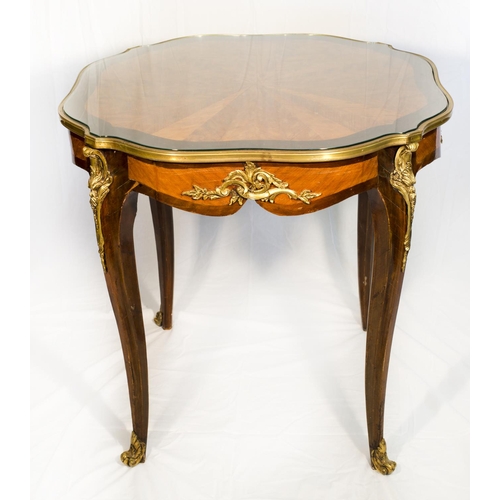 57 - A French kingwood and walnut centre table with stylised spider web inlaid decoration, brass bound, o... 