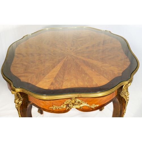 57 - A French kingwood and walnut centre table with stylised spider web inlaid decoration, brass bound, o... 