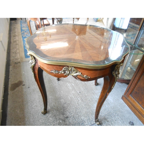 57 - A French kingwood and walnut centre table with stylised spider web inlaid decoration, brass bound, o... 