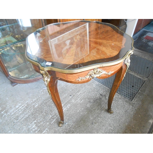 57 - A French kingwood and walnut centre table with stylised spider web inlaid decoration, brass bound, o... 