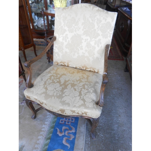 72 - A Georgian design armchair upholstered in yellow fabric with scroll arms, on cabriole legs united by... 