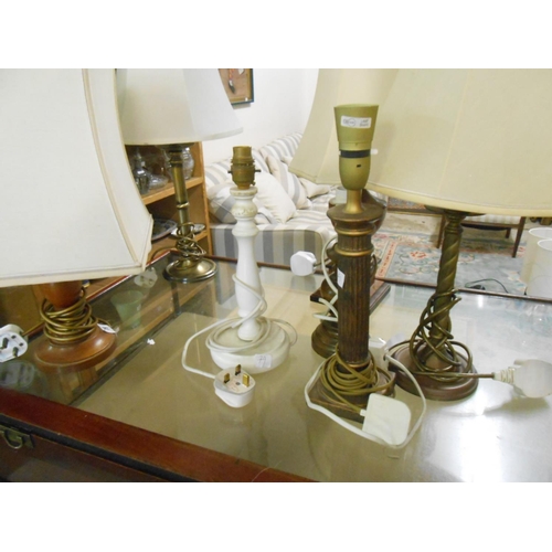 79 - A pair of turned walnut tablelamps, a turned wood tablelamp base, a tablelamp base with fluted colum... 