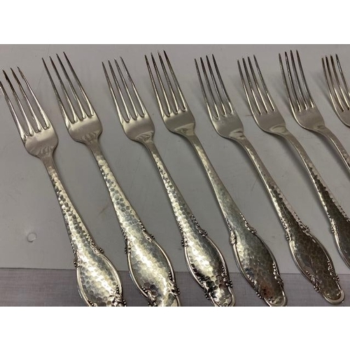 199 - Twelve Danish silver table forks with hammered and shaped handles, various makers