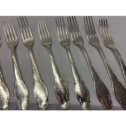 199 - Twelve Danish silver table forks with hammered and shaped handles, various makers