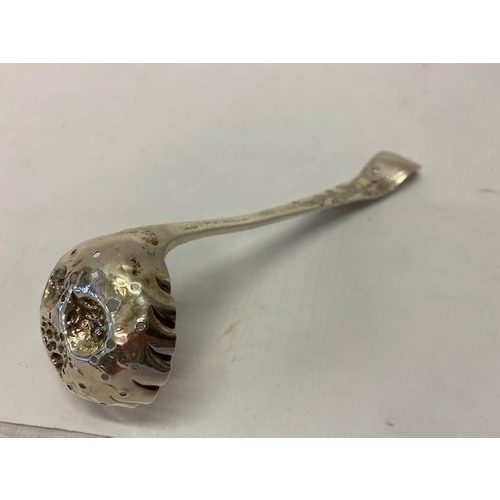 220 - A Georgian silver sugar sifting spoon with repousse decoration of fruit to the bowl - London 1808