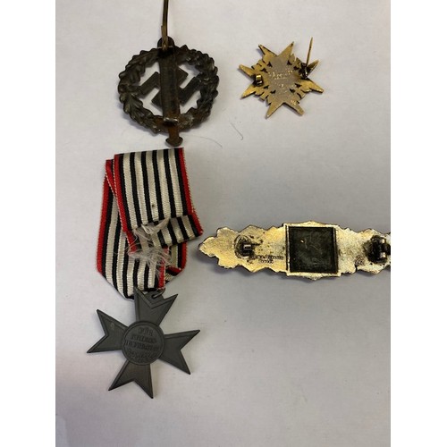 337 - Four replica German Second World War medals and badges