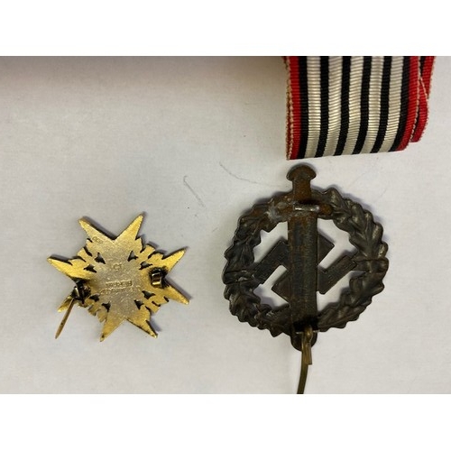 337 - Four replica German Second World War medals and badges