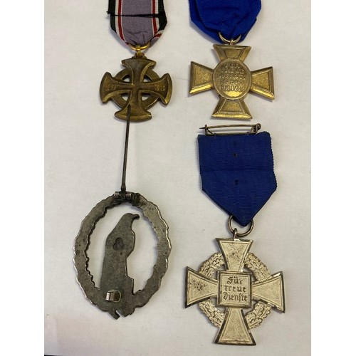 338 - Four replica German Second World War medals and badges