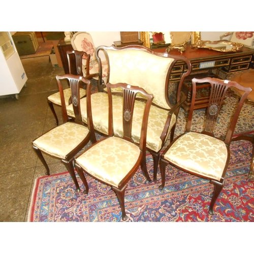 103 - An Edwardian mahogany framed settee with upholstered seat and back rest, on scrolling cabriole legs ... 