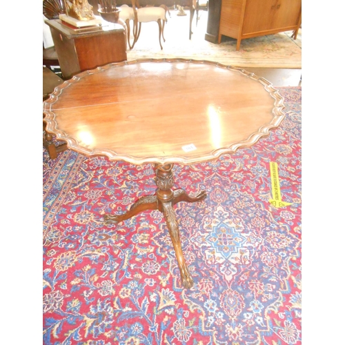 104 - A Georgian mahogany table with circular hinged top, on lattice carved centre column, three downswept... 