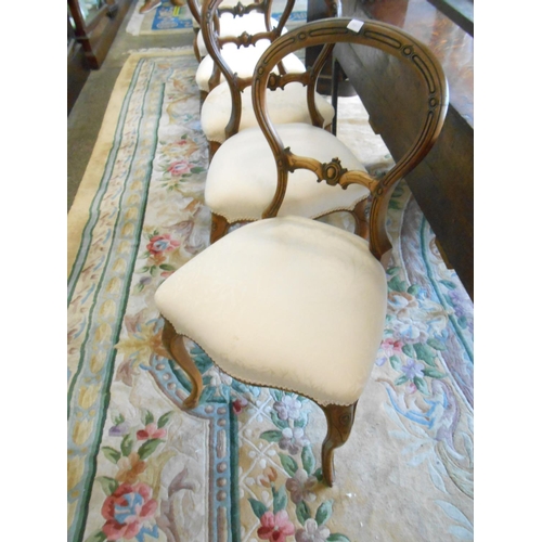70 - A set of five Victorian mahogany framed dining chairs with balloon shaped backs, carved centre splat... 