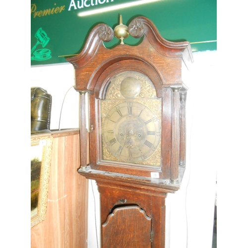 73 - An 18th Century longcase clock with brass dial, pierced brass spandrels, in an oak case with broken ... 