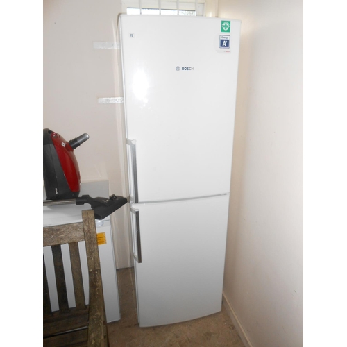 75 - A Bosch fridge freezer in a white sprayed case
