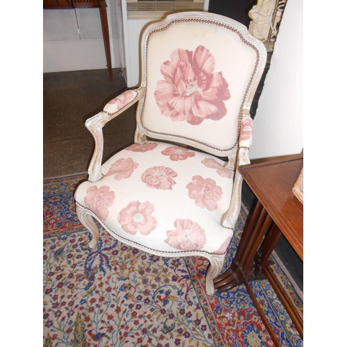 77 - A pair of reproduction limed oak fauteuils upholstered in pink floral pattern material