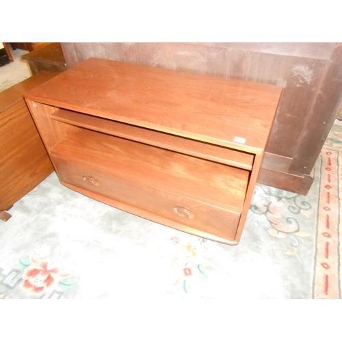 79 - An Ercol dark elm television stand, the base fitted drawer - 36in. wide