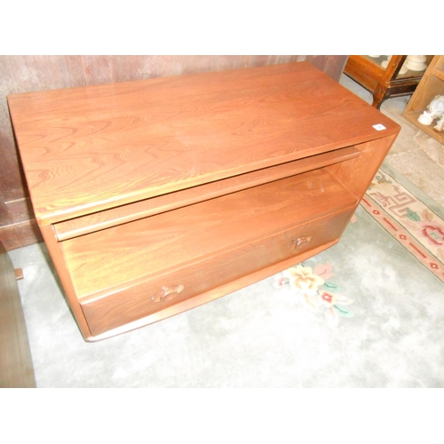 79 - An Ercol dark elm television stand, the base fitted drawer - 36in. wide