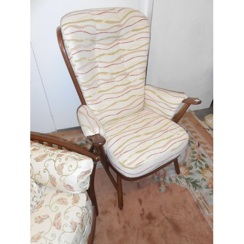 81 - A lady's modern dark elm armchair, a matching gentleman's armchair and an Ercol dark elm Evergreen p... 