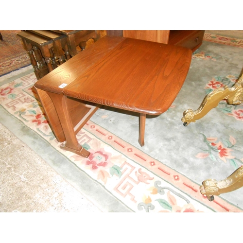 83 - A low modern Ercol dark elm occasional table fitted two deep drop flaps, on panelled ends - 27in. wi... 