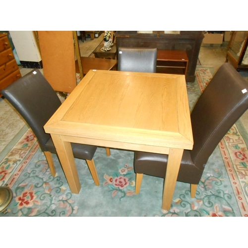 92 - A modern oak drawleaf dining table on square legs and three oak framed dining chairs with brown leat... 