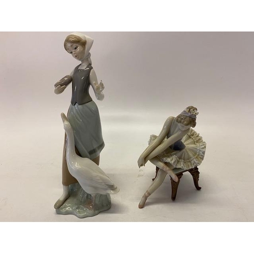 124 - Two Lladro porcelain figures of a girl with a goose - 9in. high and ballerina seated on a chair - 5 ... 