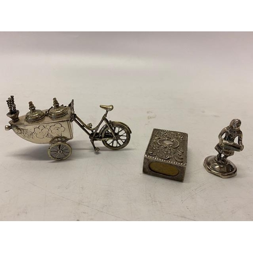 155 - A novelty Continental silver coloured metal inkwell in the form of a bicycle and cart, a silver colo... 