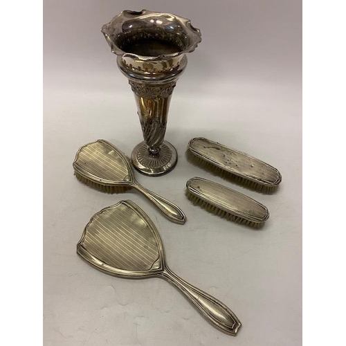 156 - A lady's four piece dressing table set mounted in engine turned silver and a silver plated spill vas... 