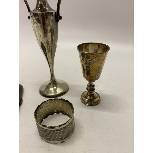 161 - A silver engine turned napkin ring, a silver Kiddush cup and a silver cigarette case and a Continent... 