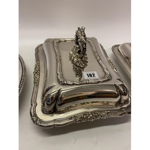 182 - A rectangular silver plated entree dish and cover with leaf scroll handle, an oval silver plated ent... 