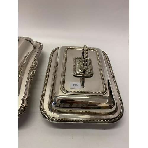 182 - A rectangular silver plated entree dish and cover with leaf scroll handle, an oval silver plated ent... 