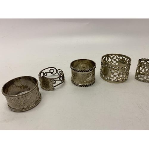 191 - Two silver napkin rings, a napkin ring with plique a jour style enamel decoration and four silver pl... 