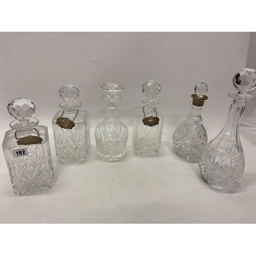 192 - A slice cut glass decanter with plain silver neck ring, three silver decanter labels, three square g... 