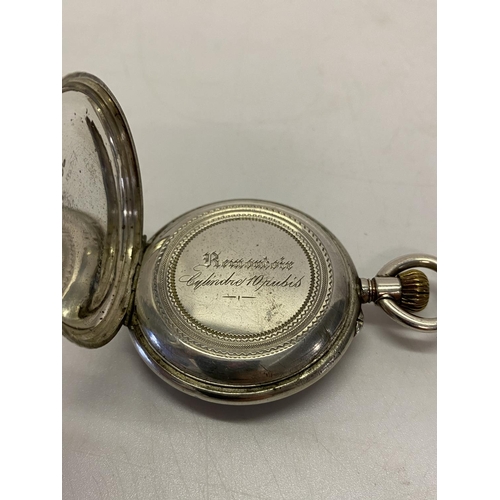 196 - A lady's fob watch, white enamel dial, in a Continental silver case, complete with metal protective ... 