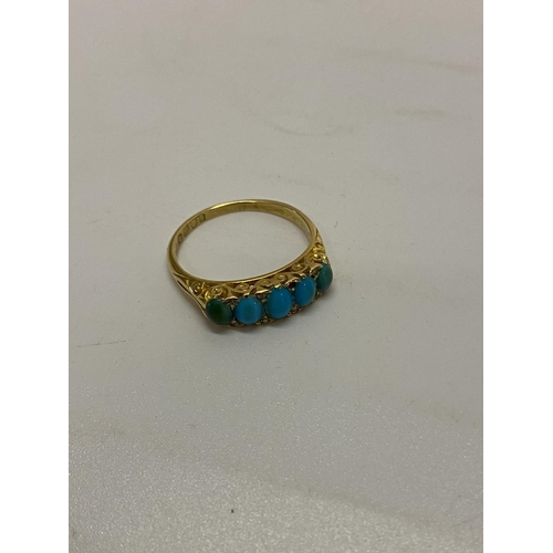 197 - A lady's ring set five graduated turquoise with diamond chip spacers, on an 18ct. gold shank