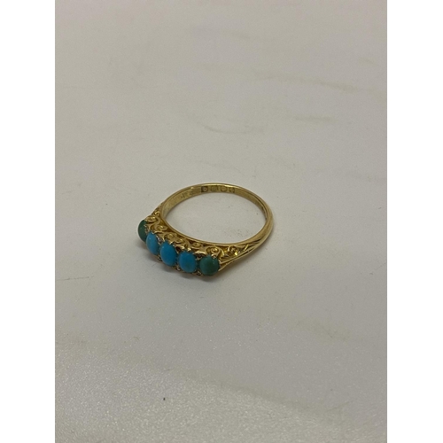 197 - A lady's ring set five graduated turquoise with diamond chip spacers, on an 18ct. gold shank