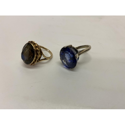 199 - A lady's ring set blue stone, on a 9ct. white gold shank and a lady's ring set smokey quartz coloure... 