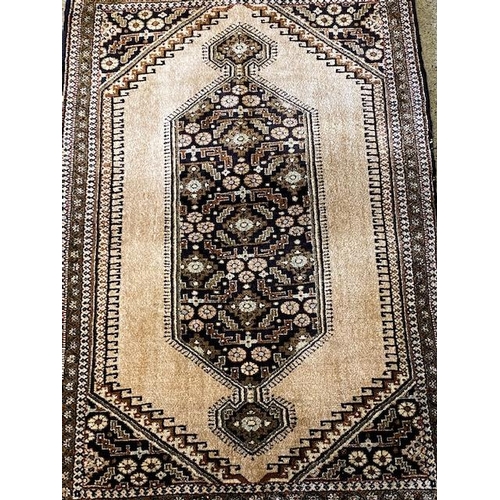 2 - An Eastern prayer rug, cream field with brown and black medallion centre - 33in. x 22in.