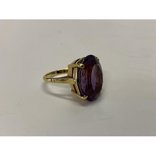 200 - A lady's ring set amethyst coloured stone, on an 18ct. gold shank