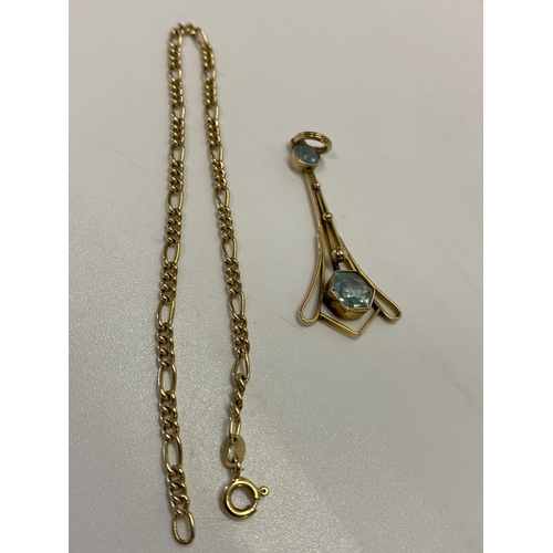 202 - A gold coloured metal pendant set aquamarine coloured stones and a 9kt. gold Figaro pattern bracelet