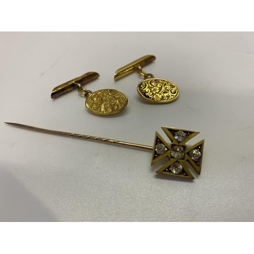 208 - A pair of 15ct. gold cufflinks and a gold coloured metal stick pin, the top in the form of a cross i... 