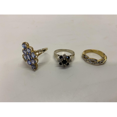 222 - A dress ring set sapphires and diamonds to flower design, on a 9ct. white gold shank, a lady's ring ... 