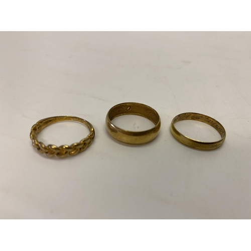 227 - An 18ct. gold keeper ring, an 18ct. gold wedding band and an 18kt. gold wedding band