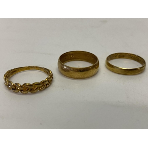 227 - An 18ct. gold keeper ring, an 18ct. gold wedding band and an 18kt. gold wedding band