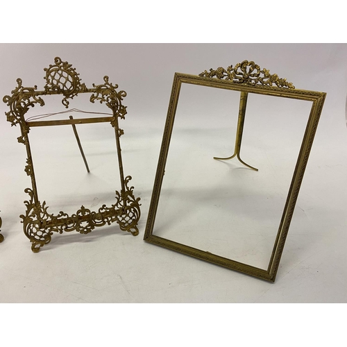 233 - A pair of brass photograph frames with scroll decoration, easel backs and one other with ribbon tie ... 