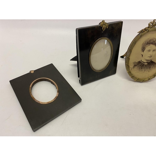 234 - Two 19th Century ebonised miniature frames and two oval brass coloured metal frames with ribbon tie ... 