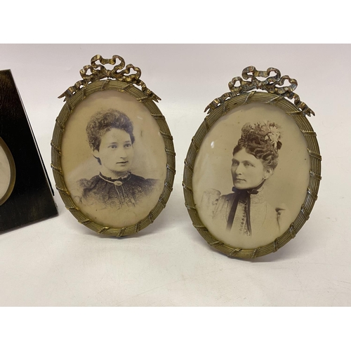 234 - Two 19th Century ebonised miniature frames and two oval brass coloured metal frames with ribbon tie ... 