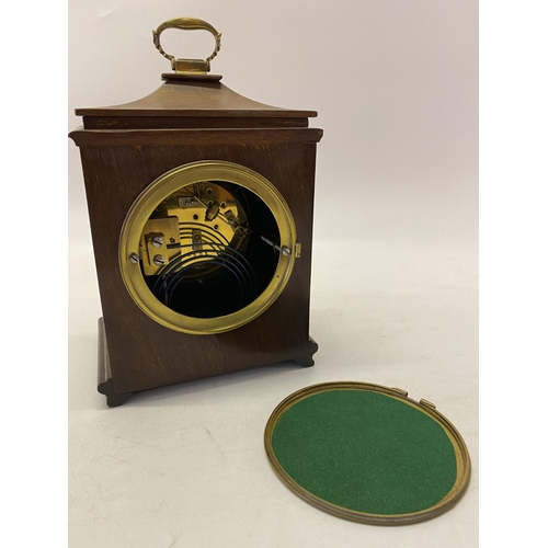 267 - A Georgian design bracket clock with white enamel dial, striking movement on a gong, in a mahogany c... 