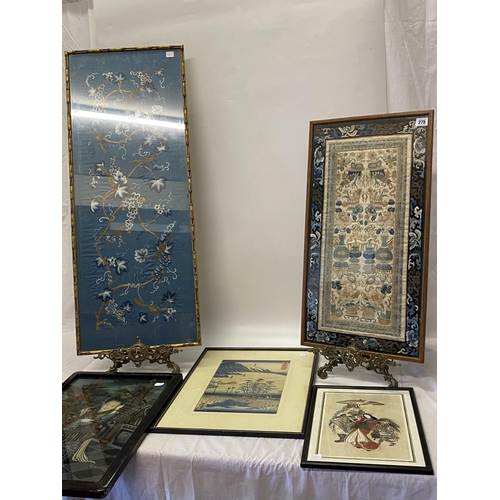 275 - A pair of Chinese Mandarin silk sleeves, framed and glazed, a Chinese silk panel, a reverse painted ... 