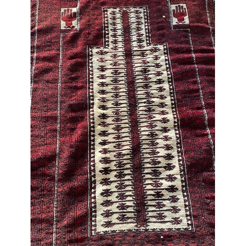 3 - An Eastern rug, red field with white stylised medallion to the centre, fringed - 52in. x 36in.